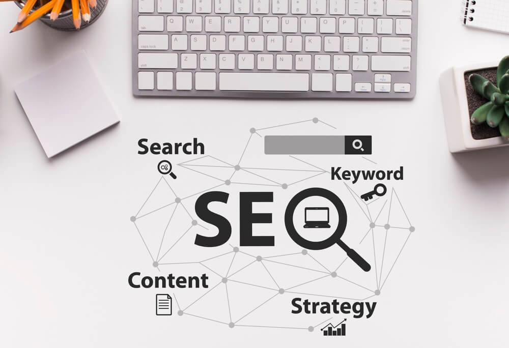 SEO diagram with search, keyword, content, and strategy on a desk with keyboard